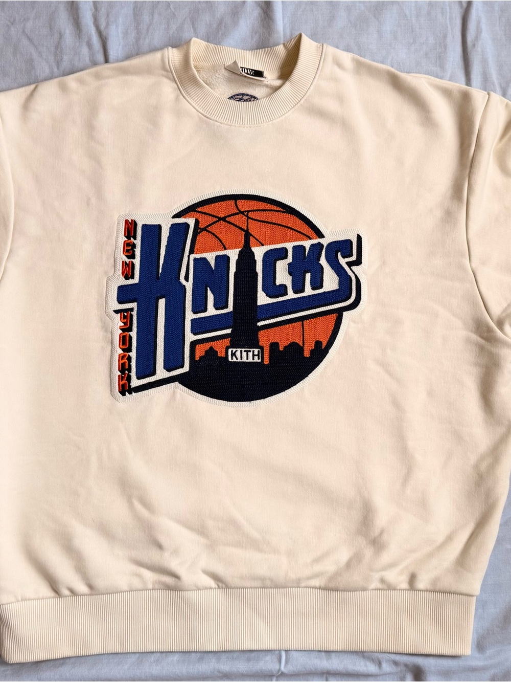 Kith Cream Crewneck with Blue & Orange Knicks Patch